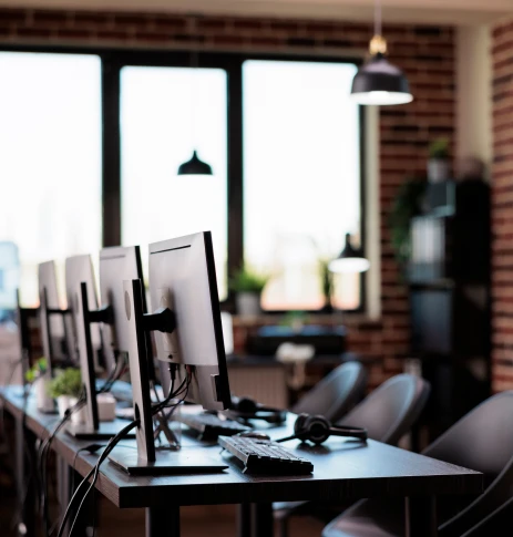 Escritório com uma mesa e vários computadores